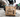 A reinforced Japanese Kraft paper bag holding a heavy food delivery order with drinks and containers without tearing