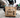 A reinforced Japanese Kraft paper bag holding a heavy food delivery order with drinks and containers without tearing